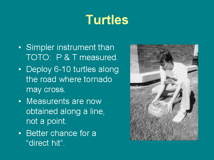 A scientist demonstrates how a turtle, an instrument-packed, lead-weighted aluminum bowl, might be placed along a road where a tornado might cross.