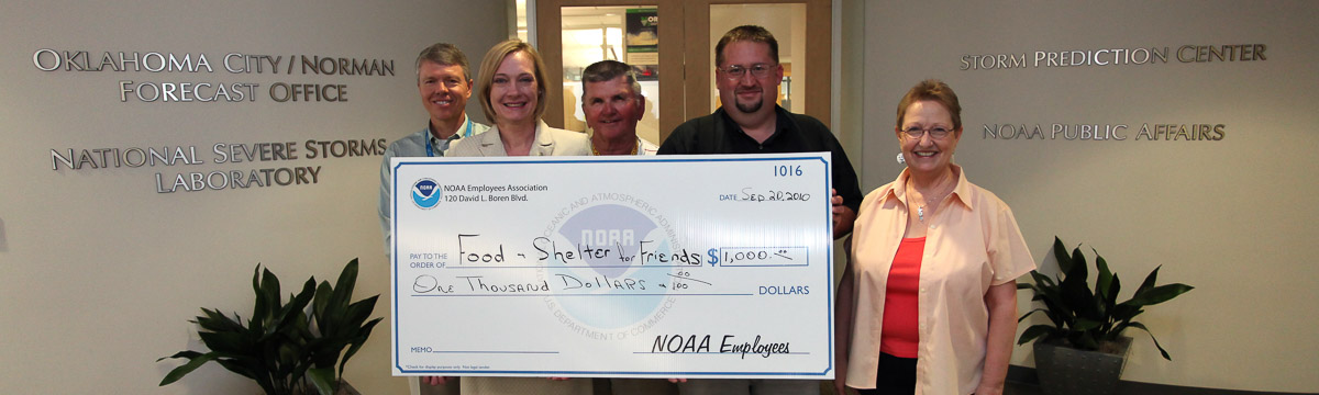NOAA employees at the National Weather Center presenting a check to a local charity