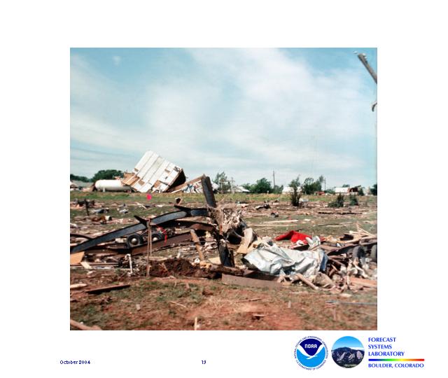 A pile of twisted metal in the foreground and a collapsed building in the background illustrate some of the damage that occurred during the Union City tornado.