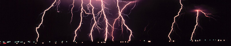 many lightning strikes over a city at night