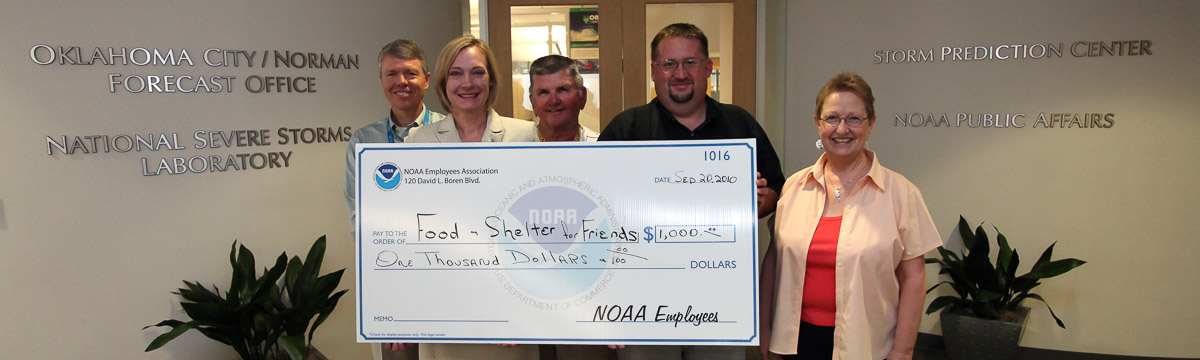 NOAA employees at the National Weather Center presenting a check to a local charity