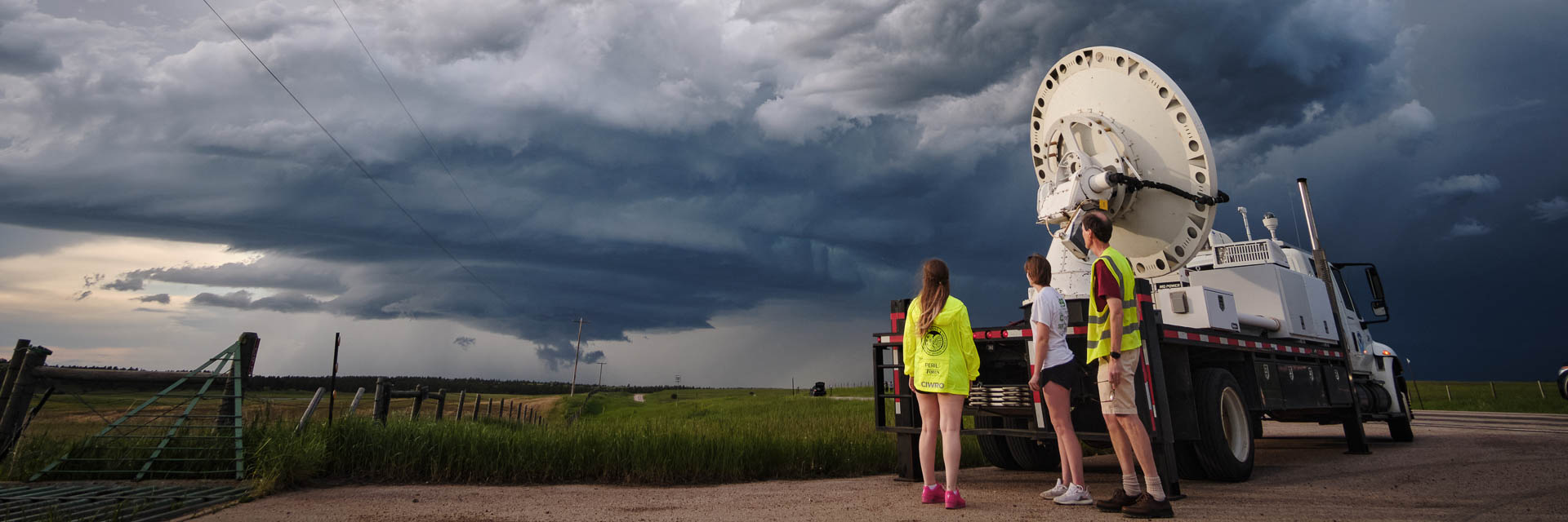 truck with equipment and NOAA logo in front of storm clouds