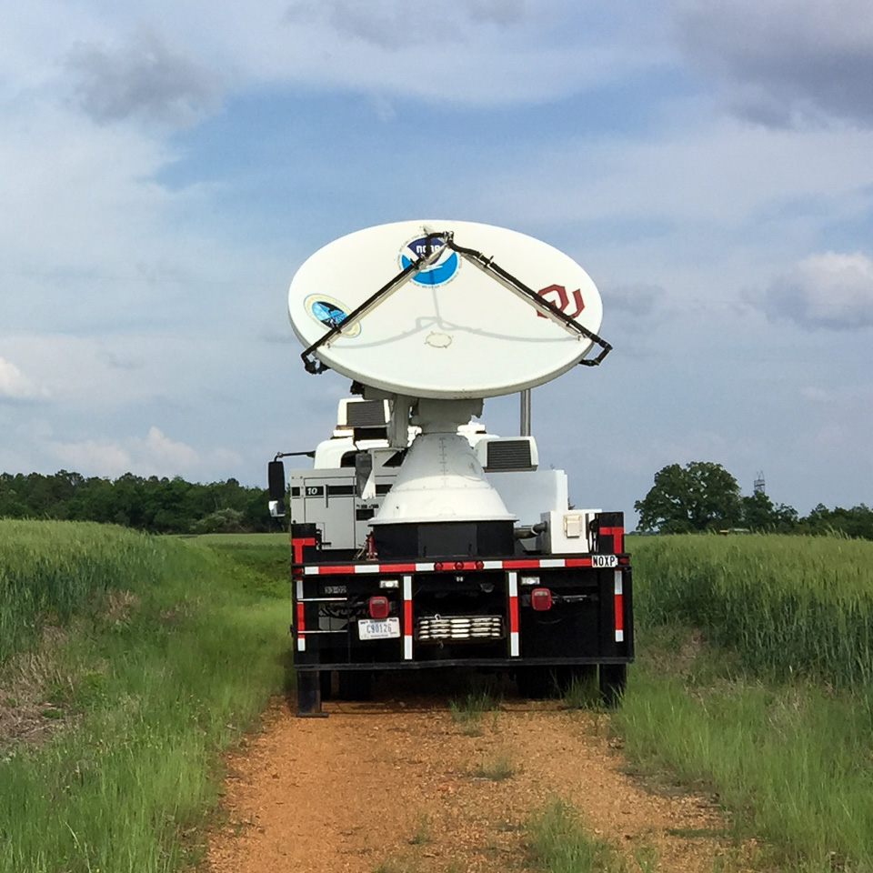 radar mounted on truck, driving on dirt path through a grassy field
