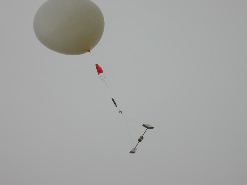 Balloon flight following the launch. The instrument train consists (top to bottom) of a parachute, a GPS radiosonde (the cylinder), and an electric field meter for determining the electrical structure of storms.
